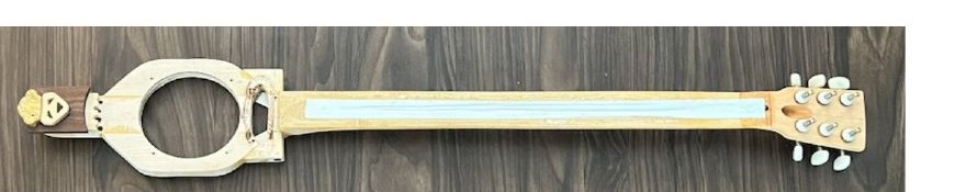 The Frankenstein guitar: a white headstock with a face and a long neck